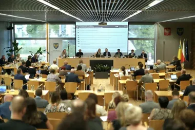 Obrady członków Samorządu Regionalnego w sali konferencyjnej z prezentacją wyświetlaną na ekranie.